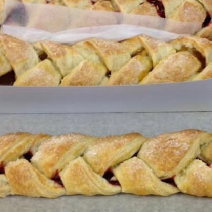 Braided fruit pastry dusted with sugar