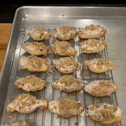 Glazed pastries with chopped nuts on a rack
