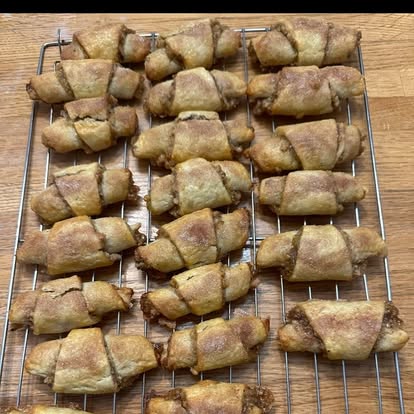 Rolled cinnamon pastries on a cooling rack